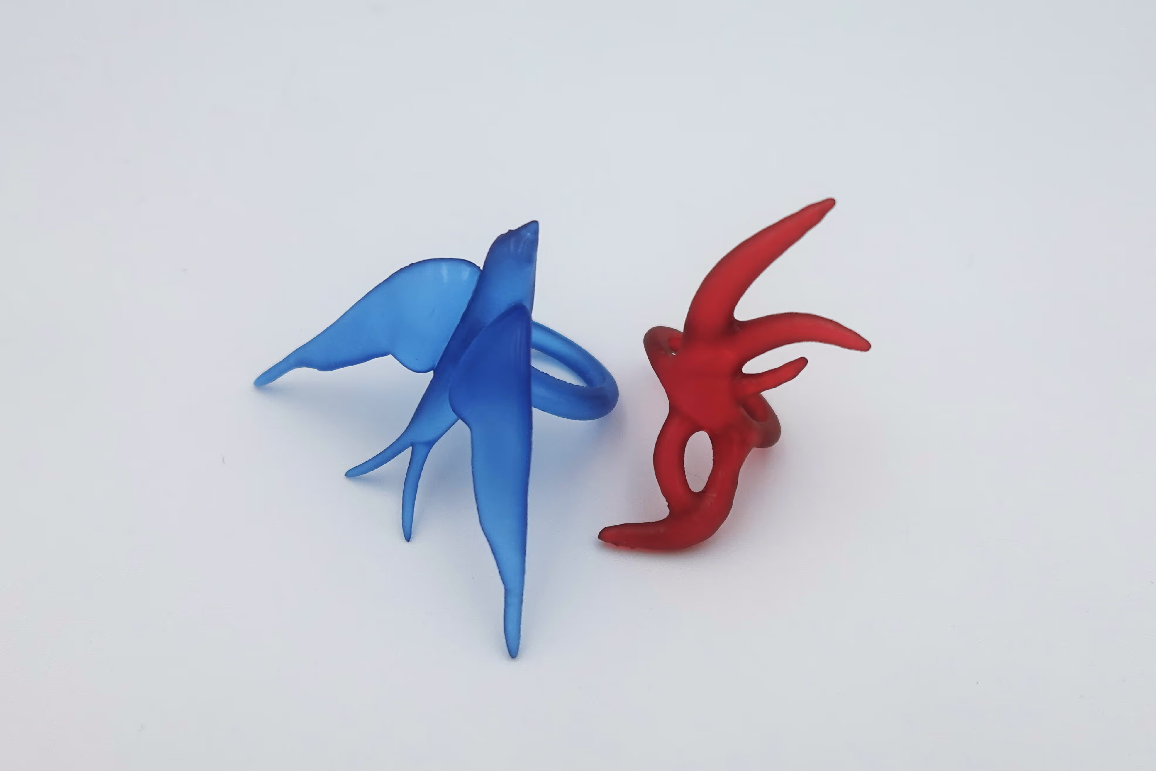 A pair of colorful toy models 3D modeled in Womp and brought to life through 3D printing